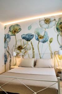 a bedroom with a mural of blue flowers on the wall at Dormi da noi in Ancona