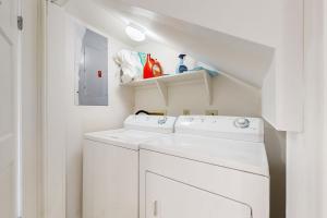 a white laundry room with a washer and dryer at Hawkins Lookout in Cudjoe Key +18 photos