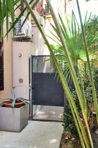 a gate in front of a house with a palm tree at Dormi da noi in Ancona