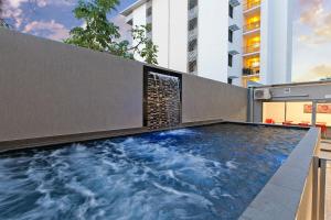 a swimming pool in the middle of a building at Argus Hotel Darwin in Darwin