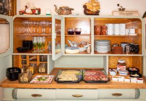 a cupboard filled with lots of food and dishes at B&B San Gavino in San Lorenzo