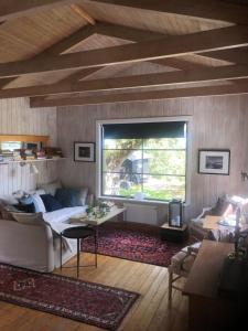 a living room with a couch and a table at Ikigaiisättra 44 in Åkersberga