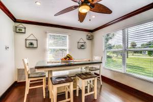 a dining room with a table and chairs and a ceiling fan at Walk to Buckingham Farms Peaceful Fort Myers Home in Fort Myers