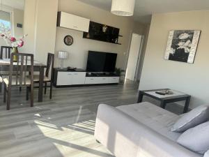 a living room with a couch and a dining room at apartamento luxury en Fuengirola in Fuengirola