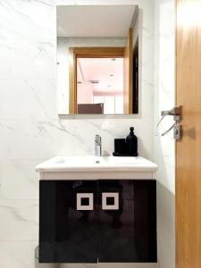 a bathroom with a sink and a mirror at Loft de Luxe au Cœur de Rabat in Rabat +20 photos