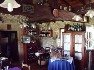 a room with a table in a bar with bottles at Casal de Folgueiras Rias Baixas in Meis +17 photos