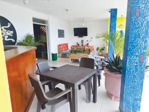 a dining room with a table and chairs at Oleajes Capurganá in Capurganá +16 photos