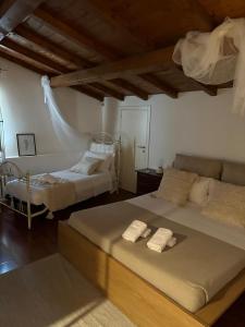 two beds in a room with two beds sidx sidx sidx sidx at Radici - La finestra sui Sassi in Matera +46 photos