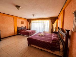 a bedroom with two beds and a window at Hotel Tiosh Abaj in Santiago Atitlán +51 photos