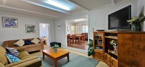 a living room with a couch and a television at Patrick Crescent 18 - Kalbarri, WA in Kalbarri