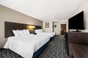 a hotel room with two beds and a flat screen tv at Best Western Bryan College Station in Bryan +24 photos