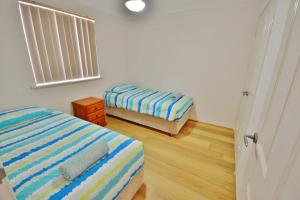 Ένα ή περισσότερα κρεβάτια σε δωμάτιο στο Surfside Retreat - Kalbarri, WA