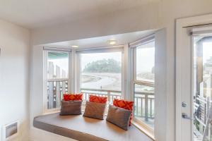 a window seat with two pillows on a balcony at Neskowin Ocean Haven in Neskowin
