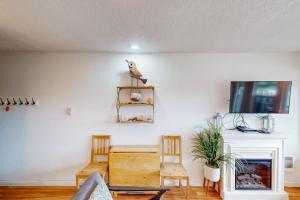 a living room with a table and chairs and a fireplace at Neskowin Ocean Haven in Neskowin