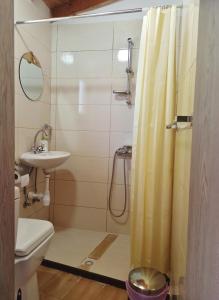 a bathroom with a shower and a toilet and a sink at Cottage in Anogyra in Anoyira +16 photos