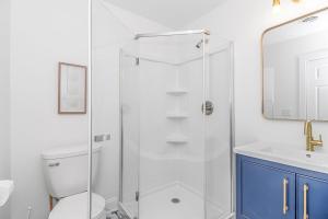 a bathroom with a shower and a toilet and a sink at Sunny Shore Retreat Near Beach in Myrtle Beach +14 photos