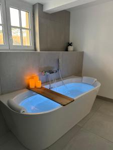 a large bath tub in a bathroom with at La Suite - Cathédrale in Chartres +9 photos