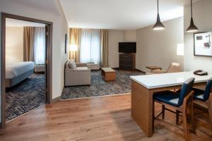 a hotel room with a bed and a living room at Candlewood Suites Arundel Mills / BWI Airport by IHG in Hanover +29 photos