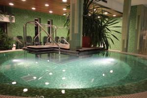 a pool in a hotel with a water slide at Hotel Yacht Wellness & Business in Siófok