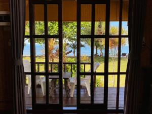 a view of a table and chairs through a window at Koh Chang Bailan Beach Resort in Ko Chang