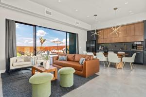 a living room and kitchen with a couch and a table at Pool-Spa -DayBeds- Firepit-Golf in Joshua Tree