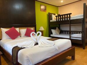 a bedroom with two beds and two bunk beds at Koh Chang Bailan Beach Resort in Ko Chang