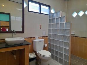a bathroom with a toilet and a sink and a window at Koh Chang Bailan Beach Resort in Ko Chang