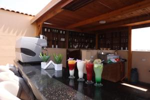 a counter with four different colored drinks on it at Pyramids Sunshine Hotel in Cairo