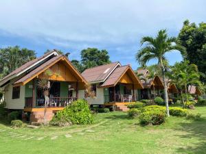 a house with palm trees in front of it at Koh Chang Bailan Beach Resort in Ko Chang