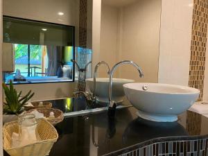 a bathroom with a sink and a mirror at Koh Chang Bailan Beach Resort in Ko Chang