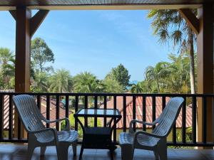 two chairs and a table on a balcony at Koh Chang Bailan Beach Resort in Ko Chang