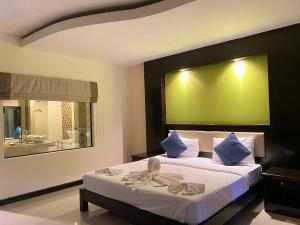a bedroom with a large bed with a green wall at Koh Chang Bailan Beach Resort in Ko Chang
