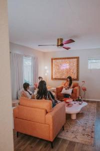 a group of people sitting in a living room at 50 Shades of Pink-Hot Tub! in Albuquerque