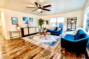 a living room with blue furniture and a ceiling fan at LP10 Downtown luxury villa with AC gameroom in Paso Robles