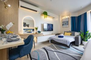 a bedroom with a bed and a table and chairs at Cerulean Bliss Condo at Tambuli Mactan Fast Wifi Netflix in Lapu Lapu City