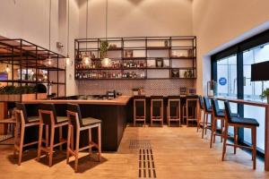 a bar in a restaurant with chairs and a counter at 601 - Rentaqui Apartamento Jardins Transamerica 2 Quartos in Sao Paulo