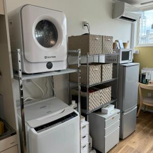 a laundry room with a washing machine on a shelf at Stay&Work HIRAJO in Yokote
