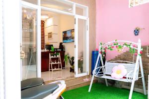 a room with a porch with a swing at Home's Lucky - Home Nha Trang in Nha Trang