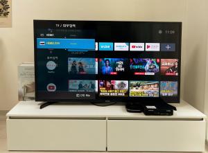 a flat screen tv sitting on top of a white cabinet at Seoul stay in Seoul