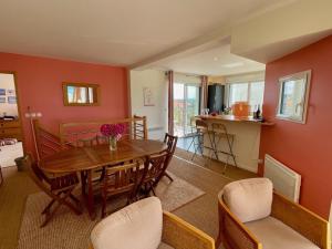 a dining room with a wooden table and chairs at Duplex élégant 3 chambres avec terrasses, draps fournis, WiFi, jardin, à Ambleteuse - FR-1-376-9 in Ambleteuse