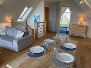 a living room with a table and a couch at Triplex de standing à Ambleteuse avec terrasse, parking et Wifi - FR-1-376-26 in Ambleteuse