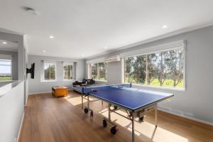 a living room with a ping pong table in it at Kilmoyla Farm Stay in Leopold