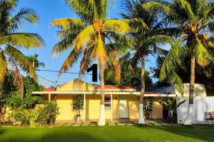 a yellow house with a number on the roof at Coco Sol 1 by MyMiamiStay in Miami +33 photos