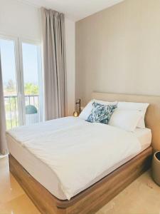 a bedroom with a large white bed with a window at Oceanview luxury Penthouse in Estepona +26 photos