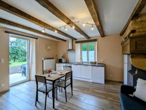 a kitchen with a table and chairs in a room at Appartement Cosy avec Jardin et Terrasse – Confort et Charme à la Campagne - FR-1-585-134 in Han-lès-Juvigny