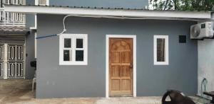 a blue house with a door and a window at Pike Guest House 2 in Dagupan