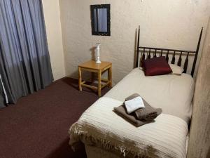 a bedroom with a bed and a table with a lamp at Botterblom 1 in Middelburg