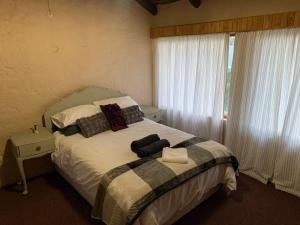 a bedroom with a bed with white sheets and pillows at Botterblom 1 in Middelburg +2 photos