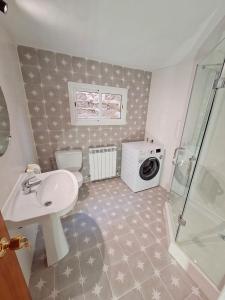 a bathroom with a sink and a washing machine at Casa Rural Teresa in Híjar