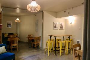 a restaurant with two tables and yellow chairs at Northwest Portland Hostel in Portland